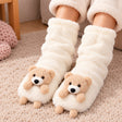 Cream slouchy fuzzy socks with a 3D tan teddy bear on each toe, worn with sherpa pyjama pants