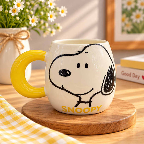 Black outline cartoon dog face filling a cream mug beside a sunny yellow ring handle