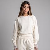 Cream lace trim set worn front on, sweatshirt cropped at the waist