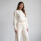 Full length cream set against a pale wall