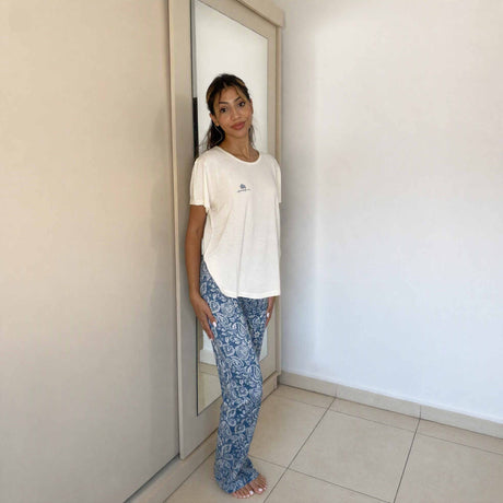 Cream top and blue floral bottoms seen from a three quarter angle