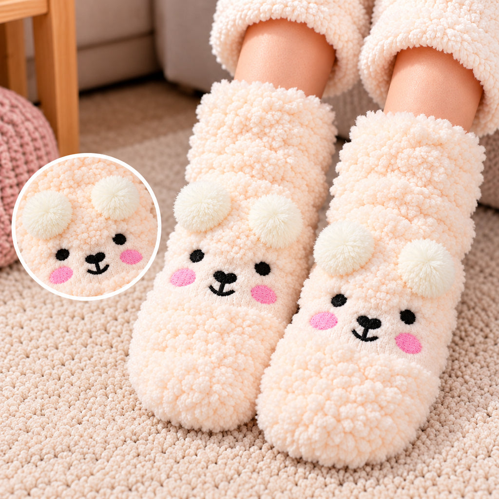 Cream fuzzy kids socks with a bear face, rosy cheeks and fluffy white pom pom ears