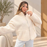 Cream teddy fleece zip jacket with deep front pockets, worn open with grey joggers