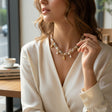 Cream speckled wrapped chain necklace with gold shell charms and a pearl drop