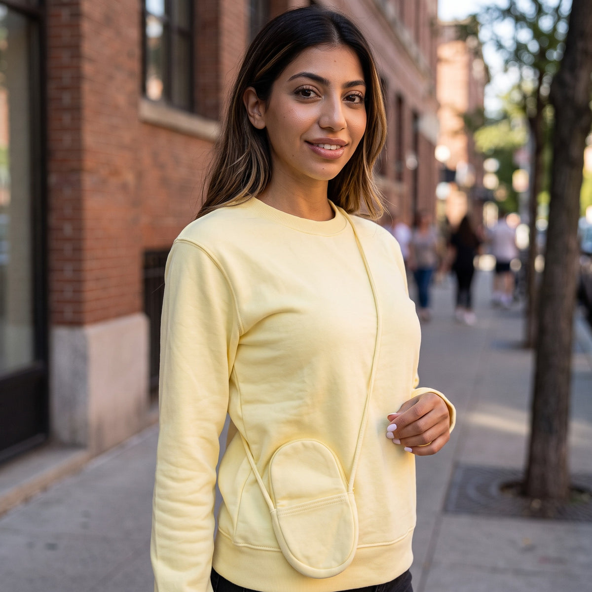 Lemon crew neck sweatshirt worn outdoors on a sunny tree lined street