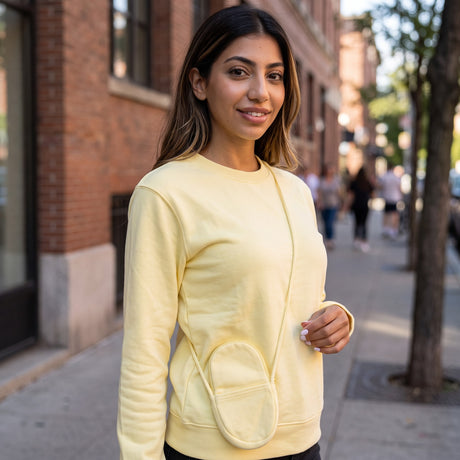 Lemon crew neck sweatshirt worn outdoors on a sunny tree lined street