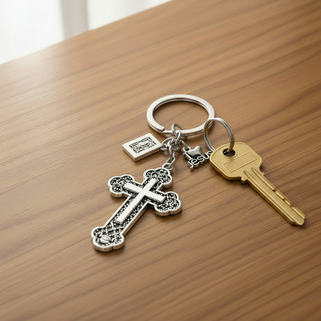 Silver filigree cross keychain with a Jesus charm on a wooden table, Jack Gifts Online Lebanon
