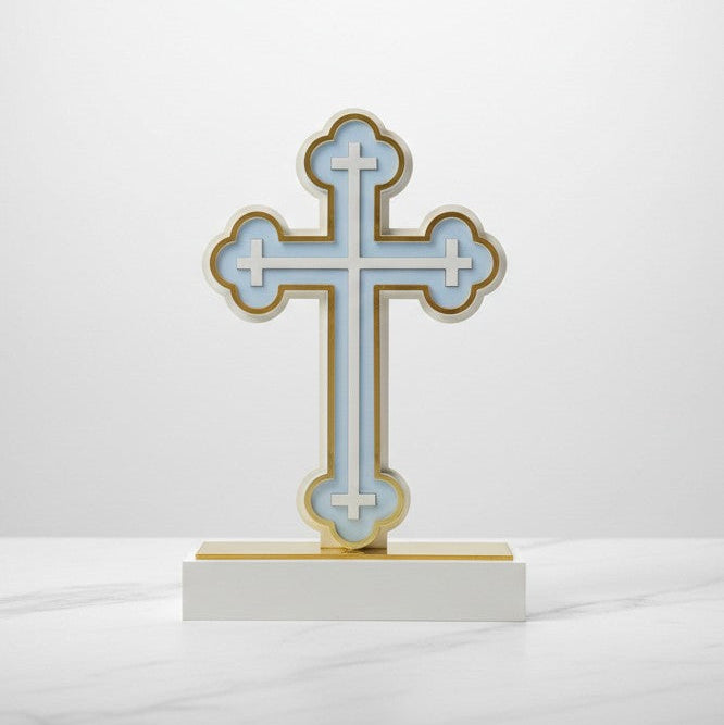 The same trefoil tipped cross in pale blue, its base capped with a gold strip