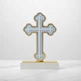 The same trefoil tipped cross in pale blue, its base capped with a gold strip
