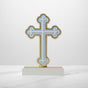 The same trefoil tipped cross in pale blue, its base capped with a gold strip