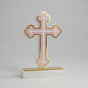 Pale pink budded acrylic cross with a gold mirror outline on a white marble block