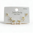 Gold tone cherry, round crystal and pearl bow stud earrings on a white display card