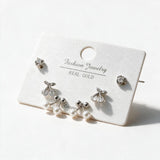 Silver tone stud set with round crystals, crystal cherries and bows with faux pearl drops