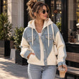 Light blue crystal denim hoodie jacket with cream knit sleeves and rhinestone pockets, worn with jeans on a city street