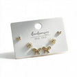 Gold tone stud set with tiny butterflies, crystal flowers and pave bow studs on a white card