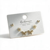 Gold tone stud set with tiny butterflies, crystal flowers and pave bow studs on a white card
