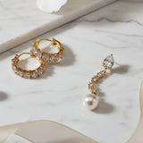 Crystal & pearl earrings set displayed on a stone counter