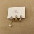 Set of crystal & pearl earrings on a jewelry card with a beige background