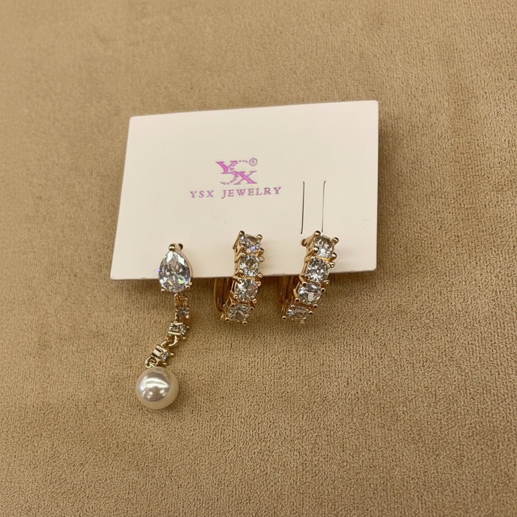 Set of crystal & pearl earrings on a jewelry card with a beige background