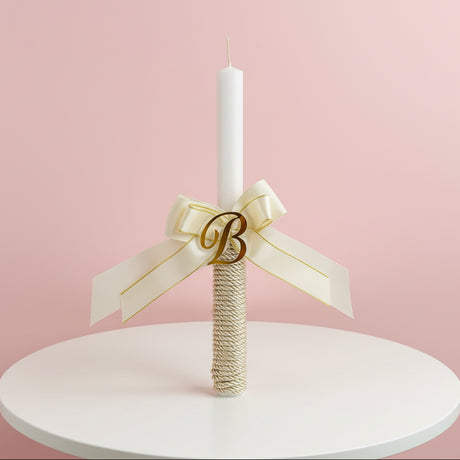 Classic candle with a cream bow, gold glitter base and letter B
