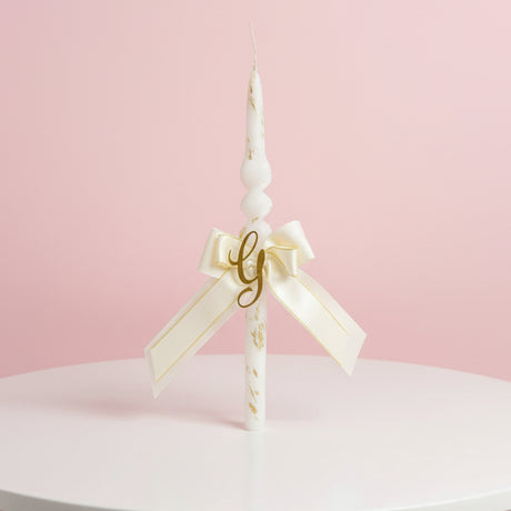 Spiral candle with a cream and gold bow and gold letter G