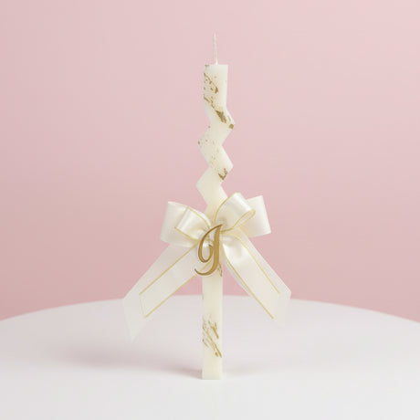 Zigzag candle with a cream and gold ribbon bow and gold letter