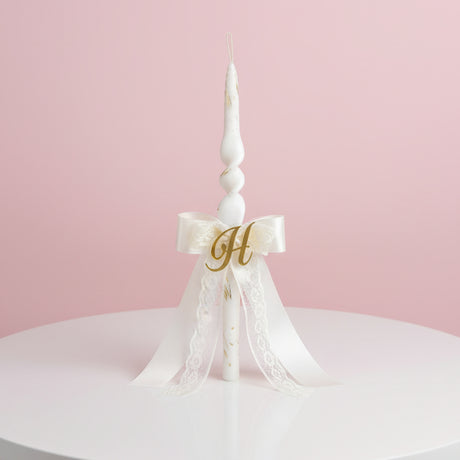 Spiral candle with a lace bow and gold letter charm
