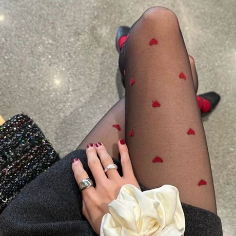 Person wearing sheer stockings with red heart patterns