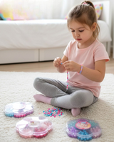 Girl threading a beaded bracelet beside three open flower shaped bead cases