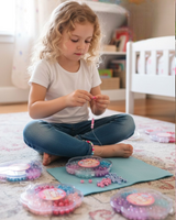 Flower shaped bead cases filled with pastel pony beads and alphabet beads on a rug