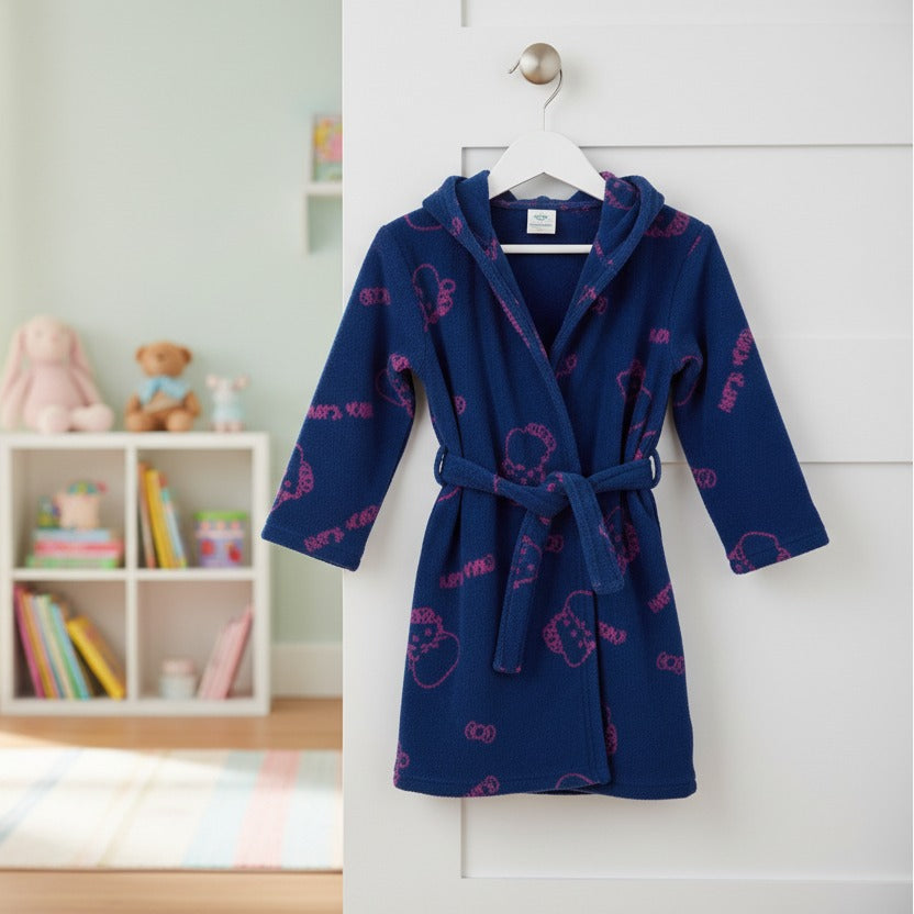 Children's navy blue robe with pink Hello Kitty prints hanging on a white door