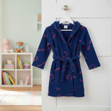 Children's navy blue robe with pink Hello Kitty prints hanging on a white door