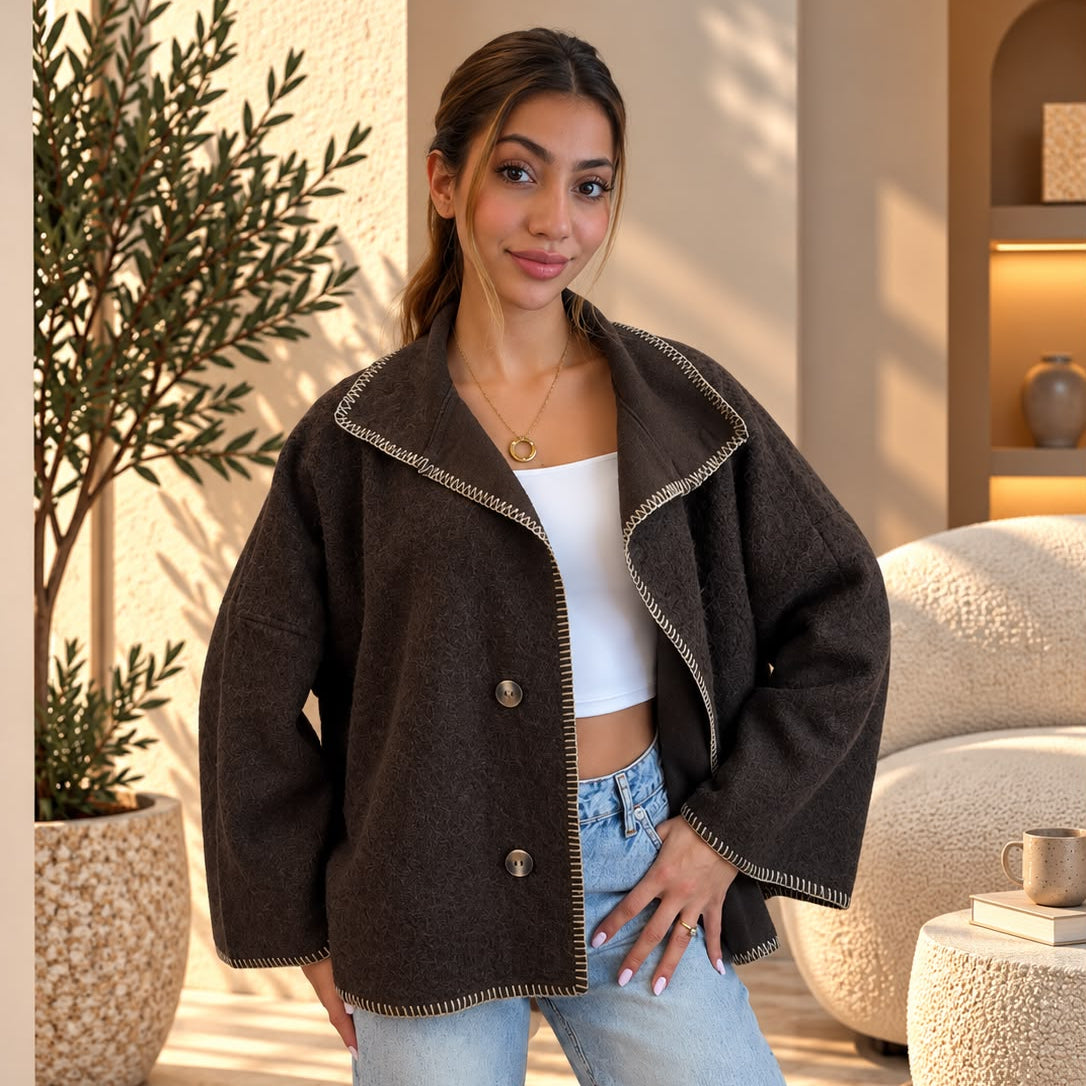 Dark brown wool jacket with contrast whipstitch trim worn open over a white top