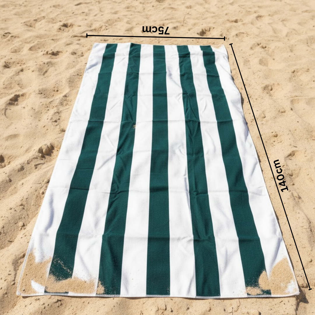 Green and white striped beach towel on sand with 75x140 cm size measurements indicated