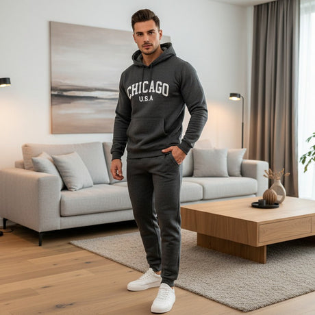 Man wearing a dark grey 'Chicago USA' hoodie and sweatpants in a modern living room