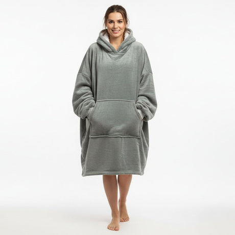 Person wearing a gray hooded blanket on a white background