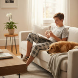 Dark grey pantacour pyjama set worn on a sofa with a golden retriever