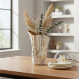 Tall ridged vase with pampas plumes and eucalyptus against white built in shelving