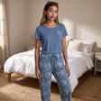 Denim blue Love print tee with white paisley drawstring pyjama trousers in a bedroom