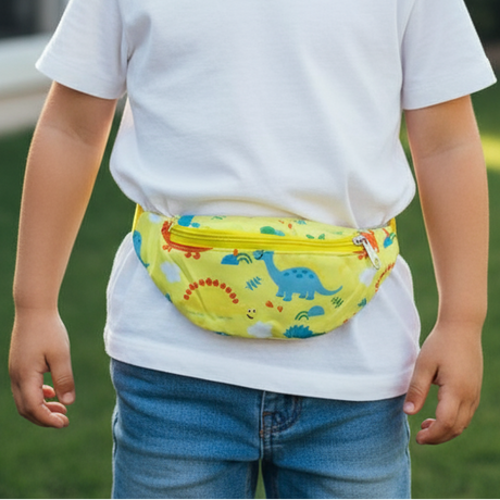 Child wearing a yellow dinosaur print waist bag with a matching yellow zip over a white tee