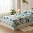 Kids blue dinosaur and digger truck bedding set on a single bed