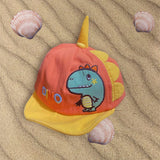 Coral corduroy sun cap with yellow brim, tall yellow crest spike and an embroidered blue dinosaur badge