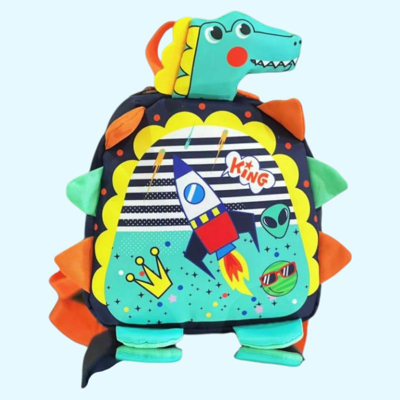 Rocket, alien and crown print on the front panel of a dino shaped toddler backpack