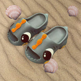 Grey dinosaur slides with moulded eyes shown on rippled sand
