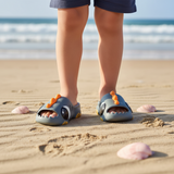 Kids grey dinosaur slides with big eyes and a spiky orange ridge strap, Jack Gifts Online Lebanon