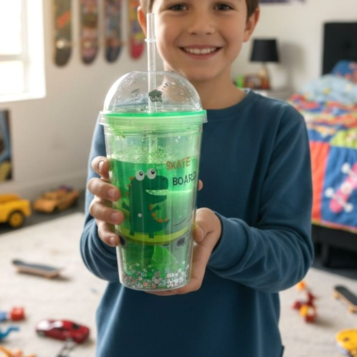 Green tumbler with a clear dome lid printed with a skateboarding dinosaur