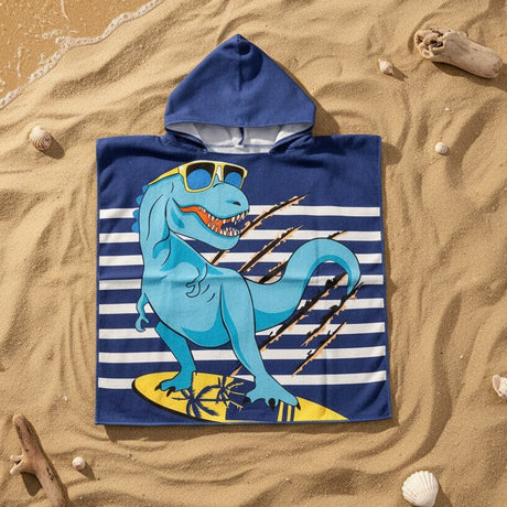 Navy striped dino surfing poncho with a blue dinosaur on a yellow palm print board flat lay