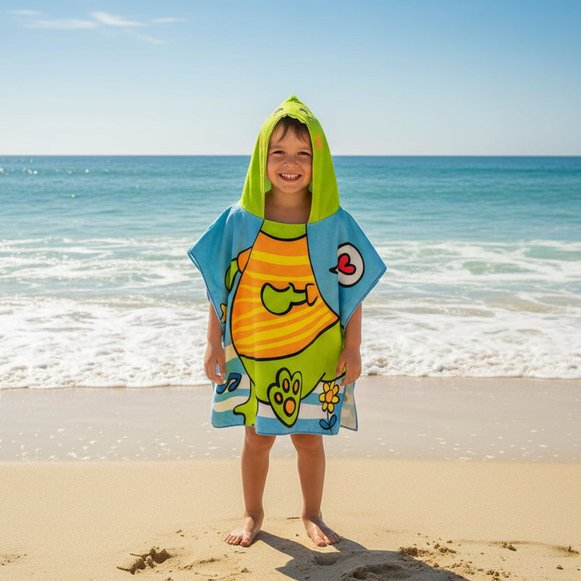 Boy wearing a light blue poncho towel with a lime green hood and a chubby dinosaur print