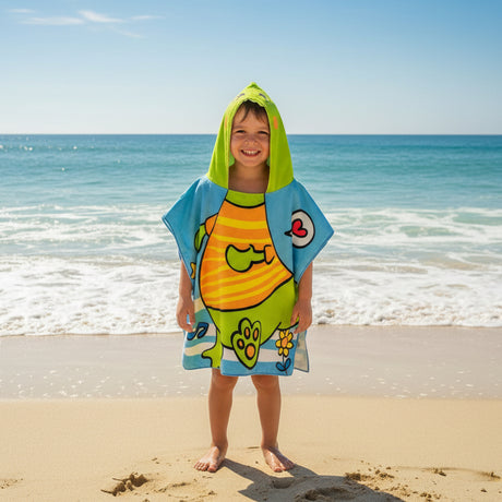 Boy wearing a light blue poncho towel with a lime green hood and a chubby dinosaur print