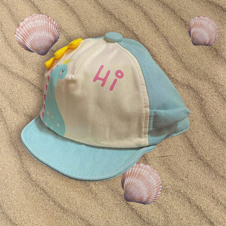 Mint green and cream baby sun cap with turquoise dinosaur print and yellow fabric spikes on the crown